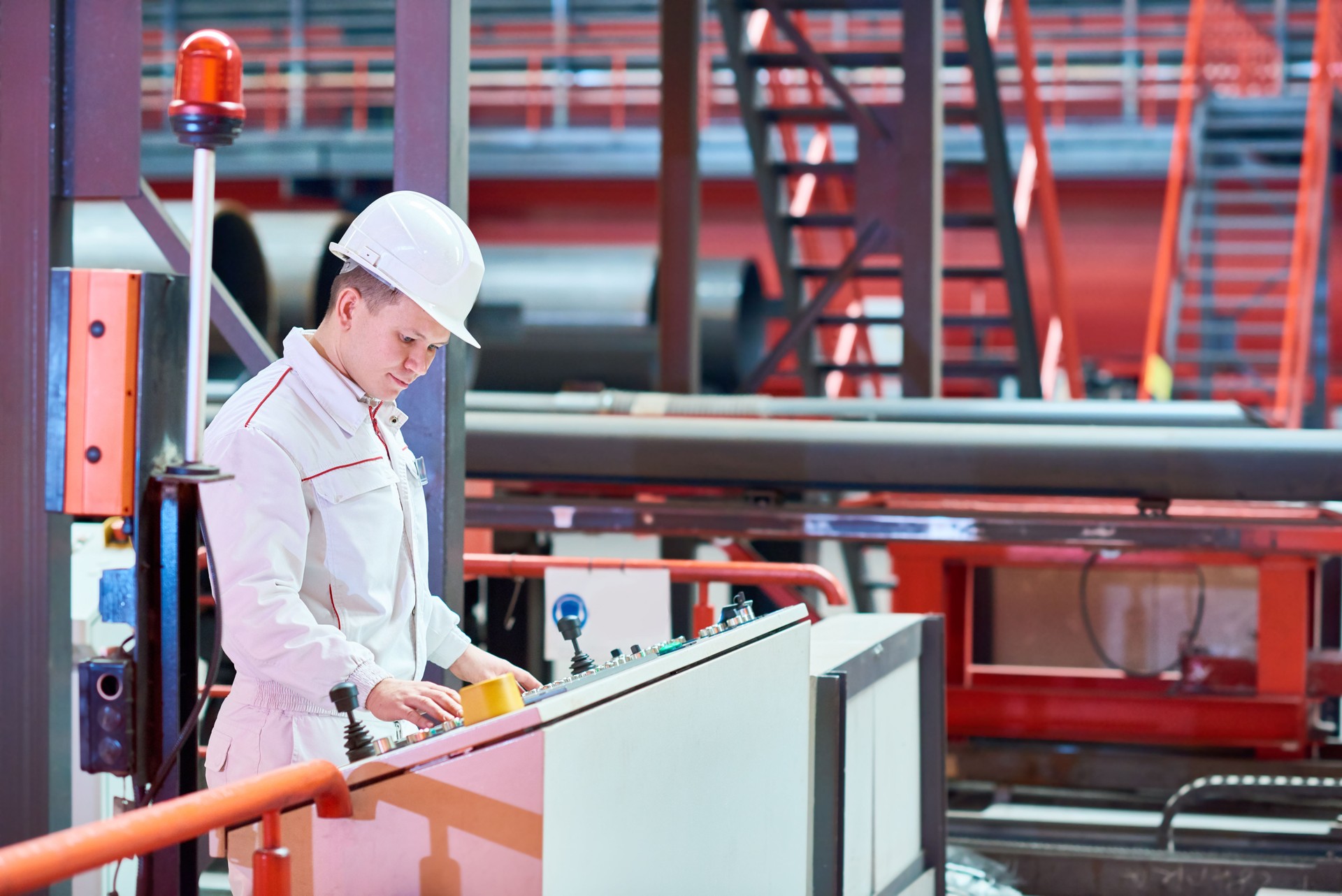 Concentrated engineer operating machine at plant