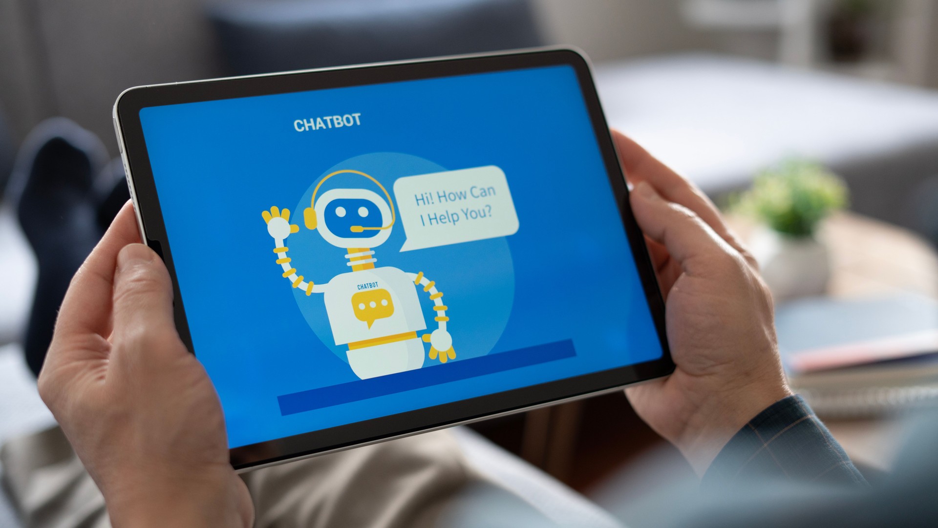 Adult man using chatbot with tablet at home