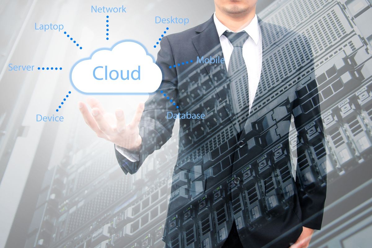 Double exposure of cloud computing concept on hand of a businessman with servers computing technology in data center creative cloud concept